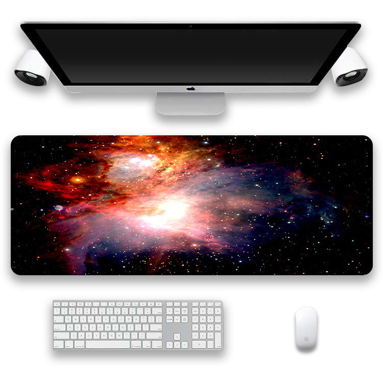Computer setup with a space-themed desk mat, keyboard, and mouse on a white background