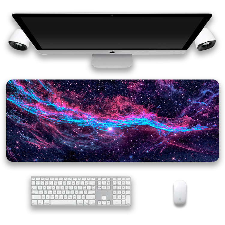 Space-themed desk mat with computer setup on a white background