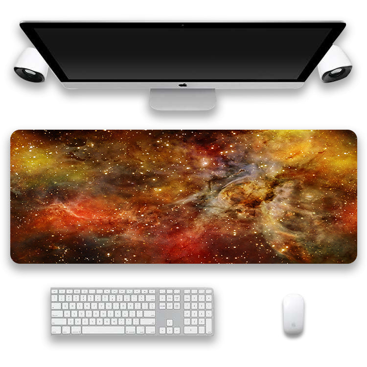 Computer setup with a space-themed desk mat, keyboard, and mouse on a white background