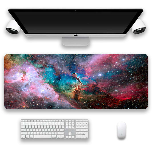 Computer setup with a desk mat featuring a colorful nebula design, keyboard, and mouse.