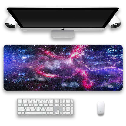 Space-themed desk mat with a computer setup including a monitor, keyboard, and mouse.